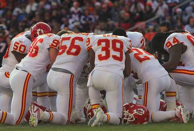DENVER, CO - JANUARY 01:  The Kansas City Chiefs defense huddle in a moment of silence as Chris Kuper #73 of the Denver Broncos is taken off the field after a leg injury at Sports Authority Field at Mile High on January 1, 2012 in Denver, Colorado. The Chiefs defeated the Broncos 7-3 as the Broncos advanced to the AFC playoffs.  (Photo by Doug Pensinger/Getty Images)