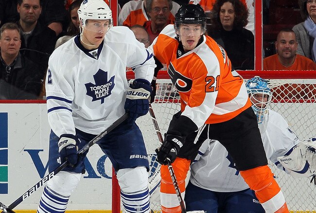 PHILADELPHIA - MARCH 07:  Luke Schenn #2, Jean-Sebastien Giguere #35, and Tyler Bozak #42 of the Toronto Maple Leafs defend against James van Riemsdyk #21 of the Philadelphia Flyers on March 7, 2010 at Wachovia Center in Philadelphia, Pennsylvania. The Flyers defeated the Leafs 3-1.  (Photo by Jim McIsaac/Getty Images)