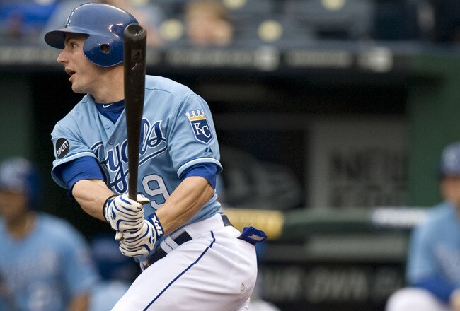 KANSAS CITY, MO - SEPTEMBER 18:   Johnny Giavotella #9 of the Kansas City Royals hits a RBI triple in the sixth inning during a game against the Chicago White Sox at Kauffman Stadium on September 18, 2011 in Kansas City, Missouri. (Photo by Ed Zurga/Getty Images)