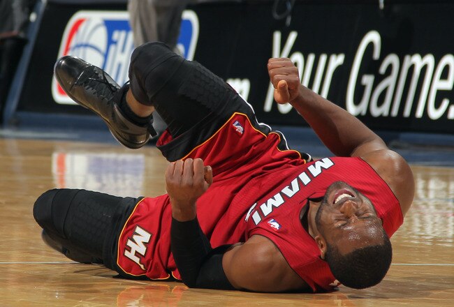 DENVER, CO - JANUARY 13:  Dwyane Wade #3 of the Miami Heat falls to the court with an injury in the fourth quarter against the Denver Nuggets at the Pepsi Center on January 13, 2012 in Denver, Colorado. Wade left the game after the injury as the Nuggets defeated the Heat 117-104. NOTE TO USER: User expressly acknowledges and agrees that, by downloading and or using this photograph, User is consenting to the terms and conditions of the Getty Images License Agreement.  (Photo by Doug Pensinger/Getty Images)