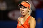 MELBOURNE, AUSTRALIA - JANUARY 16:  Caroline Wozniacki of Denmark celebrates during her first round match against Anastasia Rodionova of Australia on day one of the 2012 Australian Open at Melbourne Park on January 16, 2012 in Melbourne, Australia.  (Photo by Mark Dadswell/Getty Images)