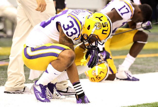 NEW ORLEANS, LA - JANUARY 09:  Odell Beckham #33 and Morris Claiborne #17 of the Louisiana State University Tigers kneel on the sideline towards the end of their game against the Alabama Crimson Tide during the 2012 Allstate BCS National Championship Game at Mercedes-Benz Superdome on January 9, 2012 in New Orleans, Louisiana.  (Photo by Andy Lyons/Getty Images)