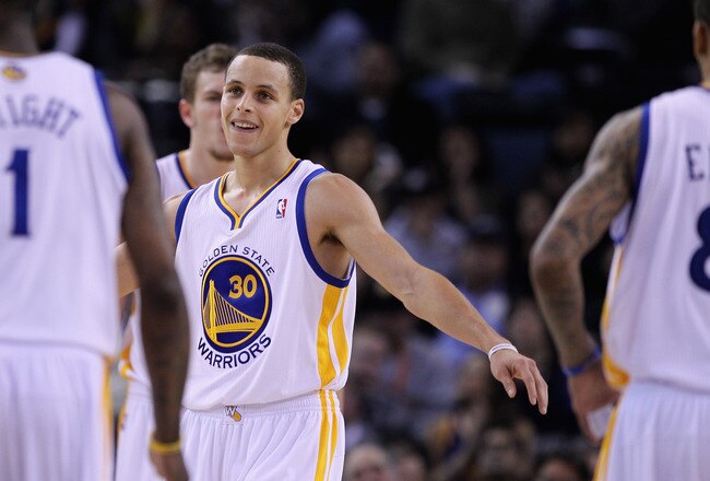 OAKLAND, CA - MARCH 25:  Stephen Curry #30 of the Golden State Warriors congratulates his teammates during their game against the Toronto Raptors at Oracle Arena on March 25, 2011 in Oakland, California. NOTE TO USER: User expressly acknowledges and agrees that, by downloading and or using this photograph, User is consenting to the terms and conditions of the Getty Images License Agreement.  (Photo by Ezra Shaw/Getty Images)