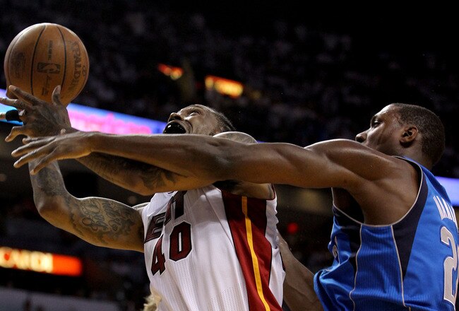MIAMI, FL - JUNE 12:  Udonis Haslem #40 of the Miami Heat attempts a shot in the second half against Ian Mahinmi #28 of the Dallas Mavericks in Game Six of the 2011 NBA Finals at American Airlines Arena on June 12, 2011 in Miami, Florida. NOTE TO USER: User expressly acknowledges and agrees that, by downloading and/or using this Photograph, user is consenting to the terms and conditions of the Getty Images License Agreement.  (Photo by Ronald Martinez/Getty Images)