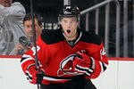 NEWARK, NJ - NOVEMBER 05:  Adam Henrique #14 of the New Jersey Devils celebrates his overtime goal against the Winnipeg Jets at the Prudential Center on November 5, 2011 in Newark, New Jersey. The Devils defeated the Jets 3-2 in overtime.  (Photo by Jim McIsaac/Getty Images)