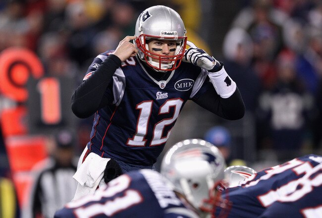 FOXBORO, MA - JANUARY 14:  Tom Brady #12 of the New England Patriots gestures as he calls signals out down the line of scrimmage against the Denver Broncos during their AFC Divisional Playoff Game at Gillette Stadium on January 14, 2012 in Foxboro, Massachusetts.  (Photo by Elsa/Getty Images)