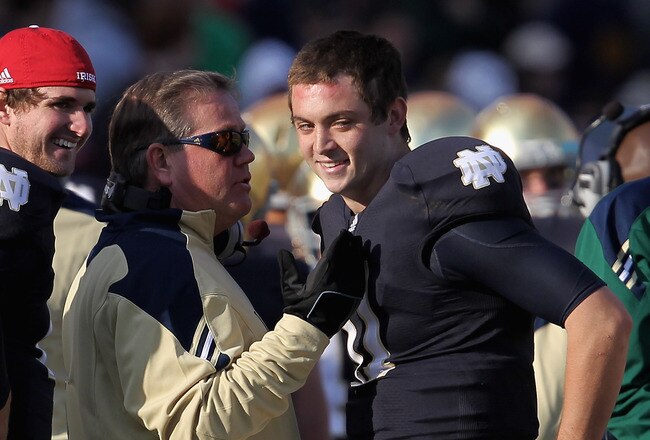 SOUTH BEND, IN - OCTOBER 29: Head coach Brian Kelly of the Notre Dame Fighting Irish talks with Tommy Rees #11 after Rees threw a touchdown pass to Michael Floyd against the Navy Midshipmen at Notre Dame Stadium on October 29, 2011 in South Bend, Indiana. Notre Dame defeated Navy 56-14.(Photo by Jonathan Daniel/Getty Images)