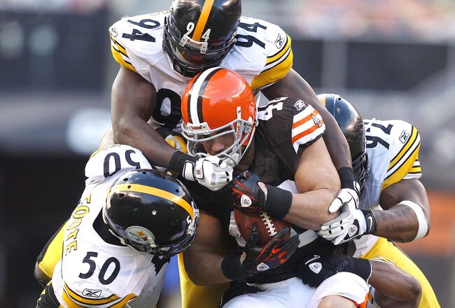 CLEVELAND, OH - JANUARY 02:  Defenders Larry Foote #50, Lawrence Timmons #94 and James Harrison #92 of the Pittsburgh Steelers tackle tailback Peyton Hillis #40 of the Cleveland Browns at Cleveland Browns Stadium on January 2, 2011 in Cleveland, Ohio.  (Photo by Matt Sullivan/Getty Images)