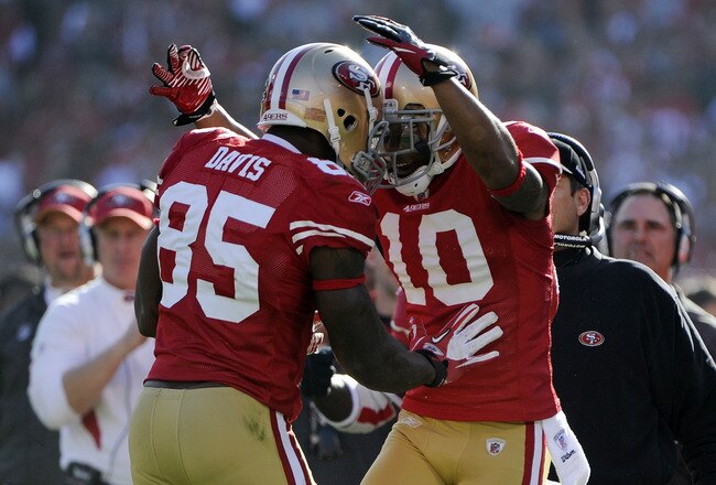 SAN FRANCISCO, CA - JANUARY 14:  Vernon Davis #85 and Kyle Williams #10 of the San Francisco 49ers celebrates after Davis goes forty nine yards on a pass play for a touchdown against the New Orleans Saints in the first quarter during the Divisional Playoffs at Candlestick Park on January 14, 2012 in San Francisco, California. The 49ers won the game 36-32. (Photo by Thearon W. Henderson/Getty Images)