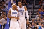 ORLANDO, FL - DECEMBER 21:  Dwight Howard #12 and Quentin Richardson #5 of the Orlando Magic talk during a preseason game against the Miami Heat at Amway Center on December 21, 2011 in Orlando, Florida. NOTE TO USER: User expressly acknowledges and agrees that, by downloading and/or using this Photograph, User is consenting to the terms and conditions of the Getty Images License Agreement.  (Photo by Mike Ehrmann/Getty Images)