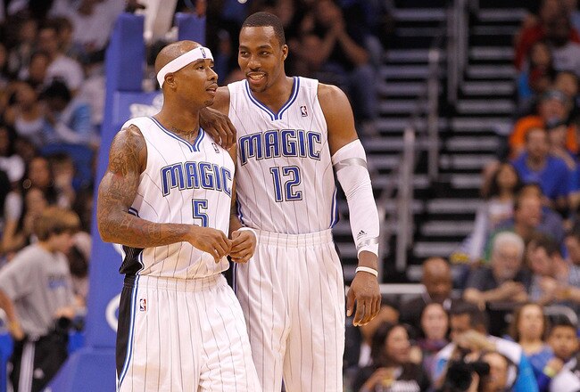 ORLANDO, FL - DECEMBER 21:  Dwight Howard #12 and Quentin Richardson #5 of the Orlando Magic talk during a preseason game against the Miami Heat at Amway Center on December 21, 2011 in Orlando, Florida. NOTE TO USER: User expressly acknowledges and agrees that, by downloading and/or using this Photograph, User is consenting to the terms and conditions of the Getty Images License Agreement.  (Photo by Mike Ehrmann/Getty Images)