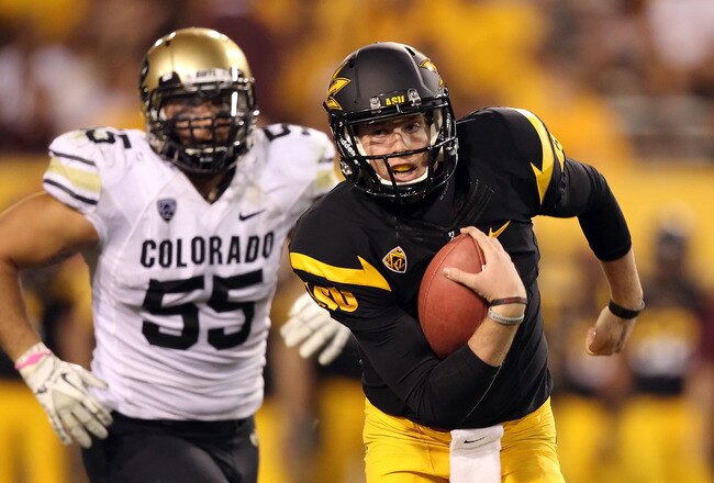 TEMPE, AZ - OCTOBER 29:  Quarterback Taylor Kelly #10 of the Arizona State Sun Devils rushes the football past David Goldberg #55 of the Colorado Buffaloes during the college football game at Sun Devil Stadium on October 29, 2011 in Tempe, Arizona. The Sun Devils defeated the Buffaloes 48-14. (Photo by Christian Petersen/Getty Images)