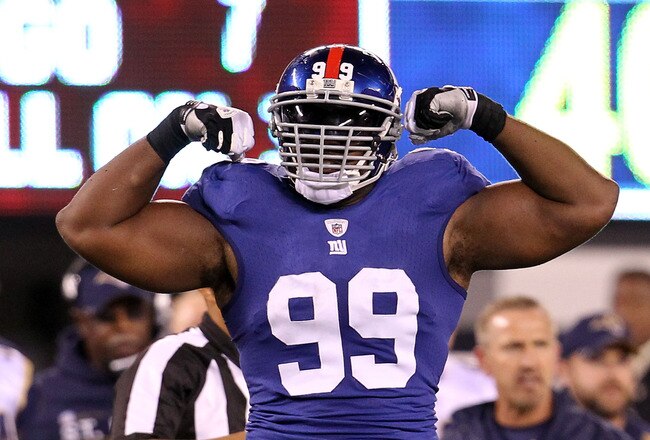 EAST RUTHERFORD, NJ - SEPTEMBER 19:  Chris Canty #99 of the New York Giants celebrates a defensive play against the St. Louis Rams at MetLife Stadium on September 19, 2011 in East Rutherford, New Jersey.  (Photo by Al Bello/Getty Images)