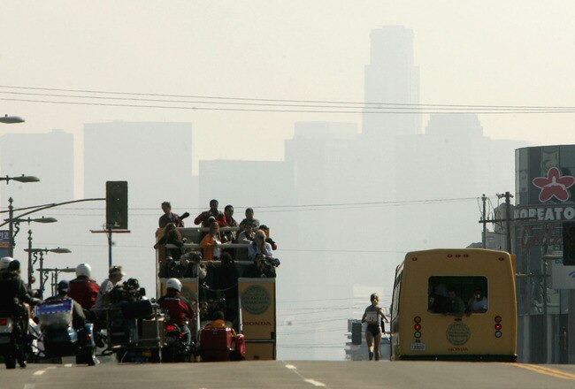 LOS ANGELES - MARCH 6:  Lyubov Denisova surorounded by a motorized press and officals entourage leads in mile 23 as she heads toward the downtown skyline during the Los Angeles Marathon XX on March 6, 2005 in Los Angeles, California. Denisova won the elite women's division.  (Photo by Stephen Dunn/Getty Images)