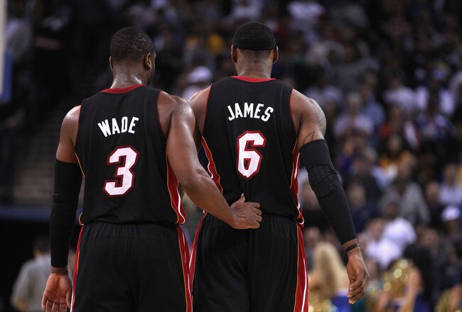 OAKLAND, CA - JANUARY 10:  LeBron James #6 of the Miami Heat talks to Dwyane Wade #3 of the Miami Heat during their game against the Golden State Warriors at Oracle Arena on January 10, 2012 in Oakland, California.  NOTE TO USER: User expressly acknowledges and agrees that, by downloading and or using this photograph, User is consenting to the terms and conditions of the Getty Images License Agreement.  (Photo by Ezra Shaw/Getty Images)