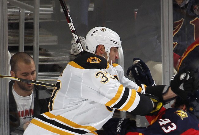 SUNRISE, FL - JANUARY 16:  Zdeno Chara #33 of the Boston Bruins checks Mike Weaver #43 of the Florida Panthers on January 16, 2012 at the BankAtlantic Center in Sunrise, Florida. The Bruins defeated the Panthers 3-2 in a shoot out. (Photo by Joel Auerbach/Getty Images)