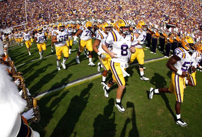 BATON ROUGE, LA - NOVEMBER 25:  Linebacker Lamin Barrow #57 and quarterback Zach Mettenberger #8 of the LSU Tigers and the rest of their teammates run out onto the field before taking on the Arkansas Razorbacks at Tiger Stadium on November 25, 2011 in Baton Rouge, Louisiana.  (Photo by Chris Graythen/Getty Images)