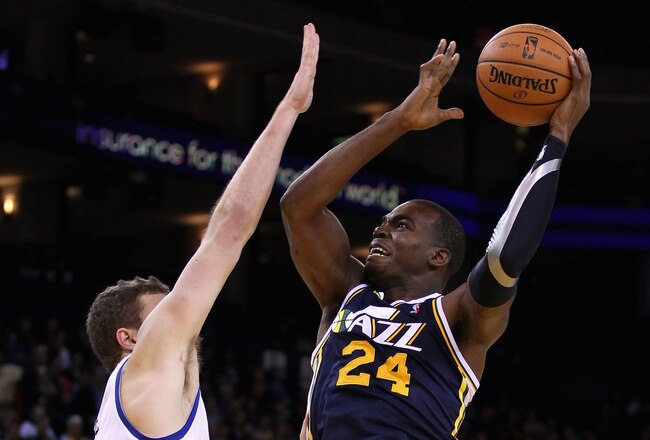 OAKLAND, CA - JANUARY 07:  Paul Millsap #24 of the Utah Jazz shoots over David Lee #10 of the Golden State Warriors at Oracle Arena on January 7, 2012 in Oakland, California.  NOTE TO USER: User expressly acknowledges and agrees that, by downloading and or using this photograph, User is consenting to the terms and conditions of the Getty Images License Agreement.  (Photo by Ezra Shaw/Getty Images)