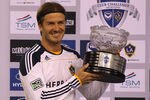 MELBOURNE, AUSTRALIA - DECEMBER 06:  David Beckham of the Galaxy poses with the man of the match trophy during the friendly match between the Melbourne Victory and LA Galaxy at Etihad Stadium on December 6, 2011 in Melbourne, Australia.  (Photo by Quinn Rooney/Getty Images)