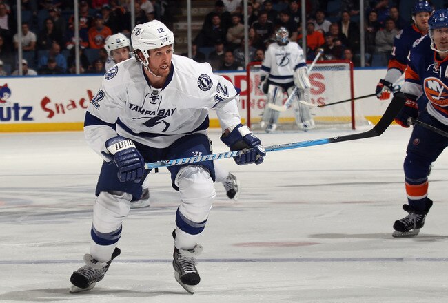 UNIONDALE, NY - DECEMBER 06:  Ryan Malone #12 of the Tampa Bay Lightning skates against the New York Islanders at the Nassau Veterans Memorial Coliseum on December 6, 2011 in Uniondale, New York. The Islanders defeated the Lightning 5-1.  (Photo by Bruce Bennett/Getty Images)