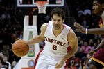 CLEVELAND, OH - DECEMBER 26:  Jose Calderon #8 of the Toronto Raptors drives to the basket against Kyrie Irving #2 of the Cleveland Cavaliers during the season opener at Quicken Loans Arena on December 26, 2011 in Cleveland, Ohio. NOTE TO USER: User expressly acknowledges and agrees that, by downloading and or using this photograph, User is consenting to the terms and conditions of the Getty Images License Agreement.  (Photo by Mike Lawrie/Getty Images)