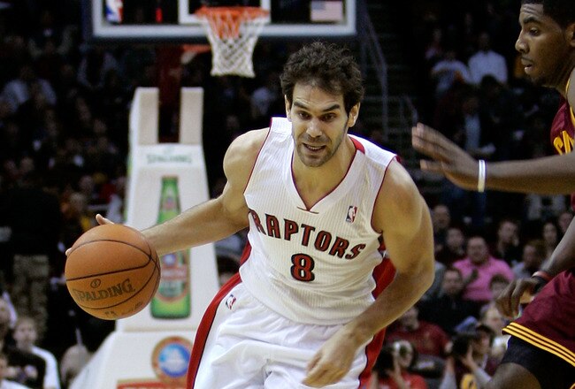 CLEVELAND, OH - DECEMBER 26:  Jose Calderon #8 of the Toronto Raptors drives to the basket against Kyrie Irving #2 of the Cleveland Cavaliers during the season opener at Quicken Loans Arena on December 26, 2011 in Cleveland, Ohio. NOTE TO USER: User expressly acknowledges and agrees that, by downloading and or using this photograph, User is consenting to the terms and conditions of the Getty Images License Agreement.  (Photo by Mike Lawrie/Getty Images)
