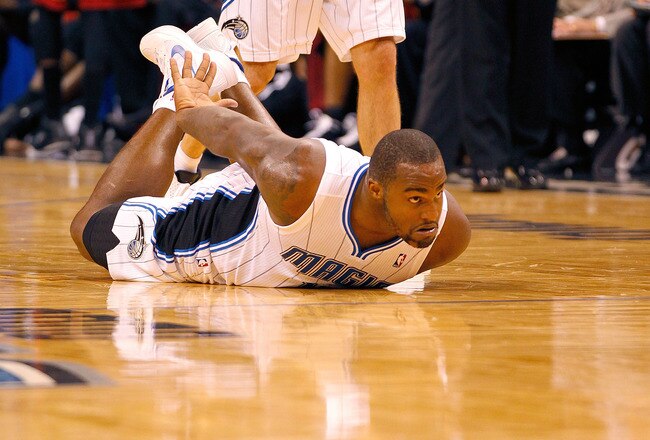 ORLANDO, FL - DECEMBER 21:  Glen Davis #11 of the Orlando Magic slides on the floor after being fouled during a preseason game against the Miami Heat at Amway Center on December 21, 2011 in Orlando, Florida. NOTE TO USER: User expressly acknowledges and agrees that, by downloading and/or using this Photograph, User is consenting to the terms and conditions of the Getty Images License Agreement.  (Photo by Mike Ehrmann/Getty Images)