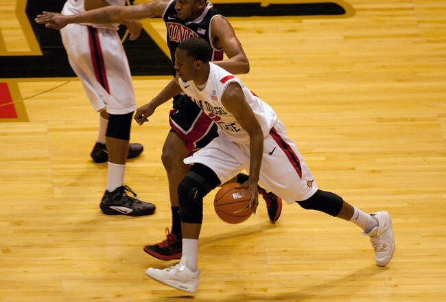 SAN DIEGO, CA - JANUARY 14 - Xavier Thames #2 of the San Diego State Aztecs dribbles past Oscar Bellfield #0 of the UNLV Runnin' Rebels during the first half of the game at Viejas Arena on January 14, 2012 in San Diego, California. (Photo by Kent C. Horner/Getty Images)