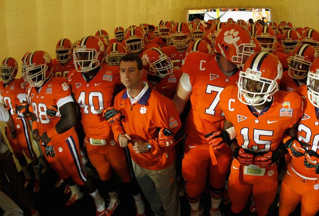 MIAMI GARDENS, FL - JANUARY 04:  Head coach Dabo Swinney (C) of the Clemson Tigers gets set to lead his team onto the field against the West Virginia Mountaineers West Virginia Mountaineers during the Discover Orange Bowl at Sun Life Stadium on January 4, 2012 in Miami Gardens, Florida.  (Photo by Mike Ehrmann/Getty Images)