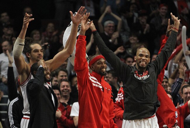 CHICAGO, IL - JANUARY 09: Members of the Chicago Bulls including (L-R) Joakim Noah #13, Richard Hamilton #32 and Taj Gibson #22 cheer after teammate Brian Scalabrine hit a shot against the Detroit Pistons at the United Center on January 9, 2012 in Chicago, Illinois. The Bulls defeated the Pistons 92-68. NOTE TO USER: User expressly acknowledges and agrees that, by downloading and or using this photograph, User is consenting to the terms and conditions of the Getty Images License Agreement. (Photo by Jonathan Daniel/Getty Images)