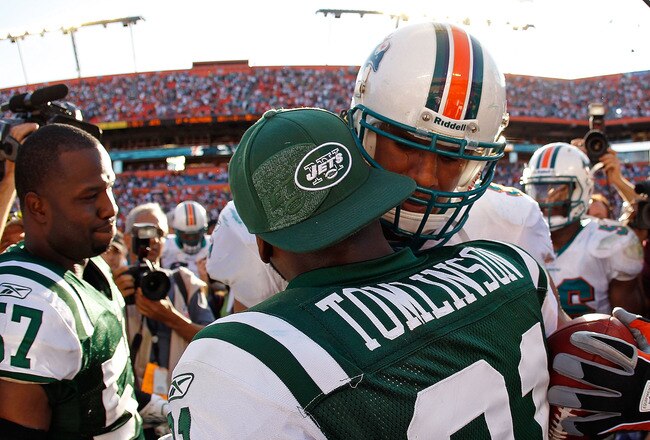 MIAMI GARDENS, FL - JANUARY 01:  Jason Taylor #99 of the Miami Dolphins shakes hands with  LaDainian Tomlinson #21 of the New York Jets after a game  at Sun Life Stadium on January 1, 2012 in Miami Gardens, Florida.  (Photo by Mike Ehrmann/Getty Images)