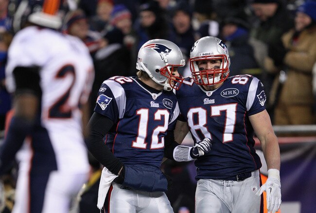 FOXBORO, MA - JANUARY 14:  (L-R) Tom Brady #12 and Rob Gronkowski #87 of the New England Patriots celebrate after Gronkowski caught a 10-yard touchdown reception from Brady in the first quarter against the Denver Broncos during their AFC Divisional Playoff Game at Gillette Stadium on January 14, 2012 in Foxboro, Massachusetts.  (Photo by Elsa/Getty Images)