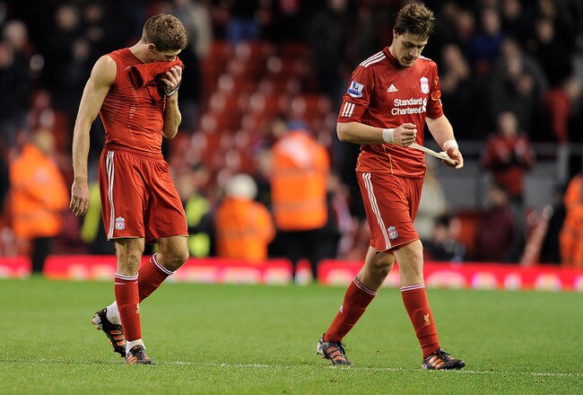 LIVERPOOL, ENGLAND - JANUARY 14:  Steven Gerrard of Liverpool walks off with Sebastian Coates  (R) at the end of the Barclays Premier League match between Liverpool and Stoke City at Anfield on January 14, 2012 in Liverpool, England.  (Photo by Michael Regan/Getty Images)