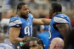 DETROIT, MI - NOVEMBER 20:  Ndamukong Suh #90 of the Detroit Lions talks with Nick Fairley #98 on the bench while playing the Carolina Panthers at Ford Field on November 20, 2011 in Detroit, Michigan.  (Photo by Gregory Shamus/Getty Images)