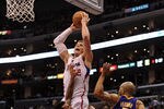 LOS ANGELES, CA - JANUARY 14:  Blake Griffin #32 of the Los Angeles Clippers is fouled as he attempts a dunk on Matt Barnes #9 and Derek Fisher #2 of the Los Angeles Lakers during a 102-94 Clipper win at Staples Center on January 14, 2012 in Los Angeles, California.  NOTE TO USER: User expressly acknowledges and agrees that, by downloading and/or using this Photograph, user is consenting to the terms and conditions of the Getty Images License Agreement.  (Photo by Harry How/Getty Images)