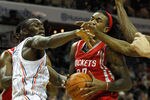 CHARLOTTE, NC - JANUARY 10:  Bismack Biyombo #0 and teammate D.J. White #8 of the Charlotte Bobcats try to stop Jordan Hill #27 of the Houston Rockets on his way to the basket during their game at Time Warner Cable Arena on January 10, 2012 in Charlotte, North Carolina.   NOTE TO USER: User expressly acknowledges and agrees that, by downloading and or using this photograph, User is consenting to the terms and conditions of the Getty Images License Agreement.  (Photo by Streeter Lecka/Getty Images)