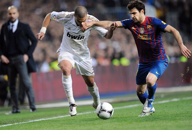 MADRID, SPAIN - JANUARY 18: Pepe (L) of Real Madrid is tackled by Cesc Fabregas of Barcelona during the Copa del Rey Quarter Finals match between Real Madrid and Barcelona at Estadio Santiago Bernabeu on January 18, 2012 in Madrid, Spain.  (Photo by Denis Doyle/Getty Images)