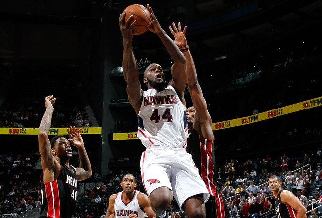 ATLANTA, GA - JANUARY 05:  Ivan Johnson #44 of the Atlanta Hawks drives against Udonis Haslem #40 and Chris Bosh #1 of the Miami Heat at Philips Arena on January 5, 2012 in Atlanta, Georgia.  NOTE TO USER: User expressly acknowledges and agrees that, by downloading and or using this photograph, User is consenting to the terms and conditions of the Getty Images License Agreement.  (Photo by Kevin C. Cox/Getty Images)