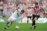 BILBAO, SPAIN - APRIL 09: Gonzalo Higuain (L) of Real Madrid tries to get past Borja Ekiza of Athletic Bilbao during the La Liga match between Athletic Bilbao and Real Madrid at San Mames Stadium on April 9, 2011 in Bilbao, Spain.  (Photo by Denis Doyle/Getty Images)