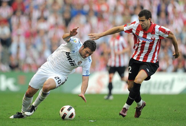 BILBAO, SPAIN - APRIL 09: Gonzalo Higuain (L) of Real Madrid tries to get past Borja Ekiza of Athletic Bilbao during the La Liga match between Athletic Bilbao and Real Madrid at San Mames Stadium on April 9, 2011 in Bilbao, Spain.  (Photo by Denis Doyle/Getty Images)