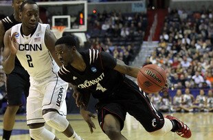 WASHINGTON - MARCH 19:  Cashmere Wright #1 of the Cincinnati Bearcats drives past Donnell Beverly #2 of the Connecticut Huskies during the third round of the 2011 NCAA men's basketball tournament at Verizon Center on March 19, 2011 in Washington, DC.  (Photo by Nick Laham/Getty Images)