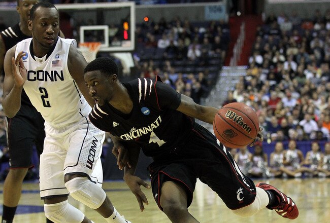 WASHINGTON - MARCH 19:  Cashmere Wright #1 of the Cincinnati Bearcats drives past Donnell Beverly #2 of the Connecticut Huskies during the third round of the 2011 NCAA men's basketball tournament at Verizon Center on March 19, 2011 in Washington, DC.  (Photo by Nick Laham/Getty Images)