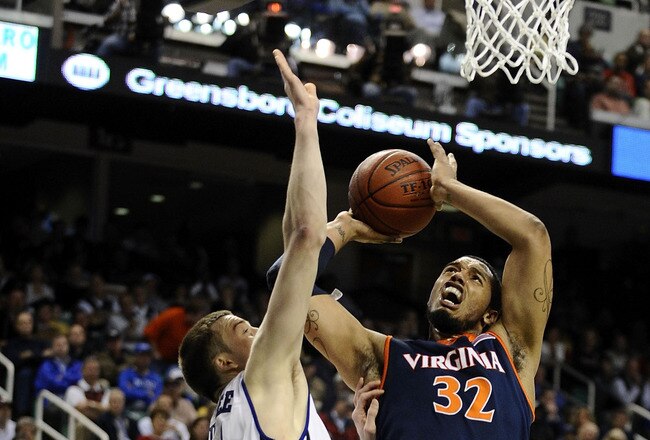 GREENSBORO, NC - MARCH 12:  MIles Plumlee #21 of the Duke Blue Devils guards Mike Scott #32  of the University of Virginia Cavaliers in their quarterfinal game in the 2010 ACC Men's Basketball Tournament at the Greensboro Coliseum on March 12, 2010 in Greensboro, North Carolina.  (Photo by Jeff Zelevansky/Getty Images)