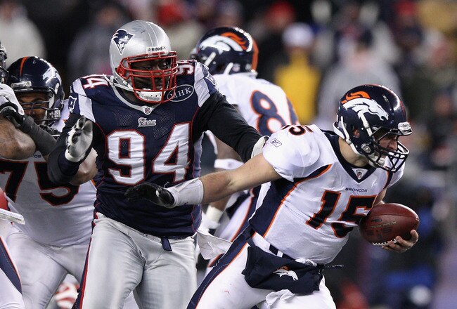 FOXBORO, MA - JANUARY 14:  Shaun Ellis #94 of the New England Patriots sackes Tim Tebow #15 of the Denver Broncos during their AFC Divisional Playoff Game at Gillette Stadium on January 14, 2012 in Foxboro, Massachusetts.  (Photo by Elsa/Getty Images)