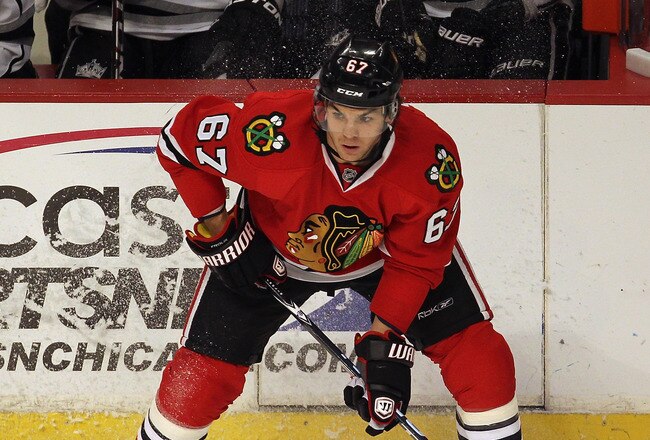 CHICAGO, IL - DECEMBER 28: Michael Frolik #67 of the Chicago Blackhawks looks to pass against the Los Angeles Kings at the United Center on December 28, 2011 in Chicago, Illinois.  The Kings defeated the Blackhawks 2-0.  (Photo by Jonathan Daniel/Getty Images)