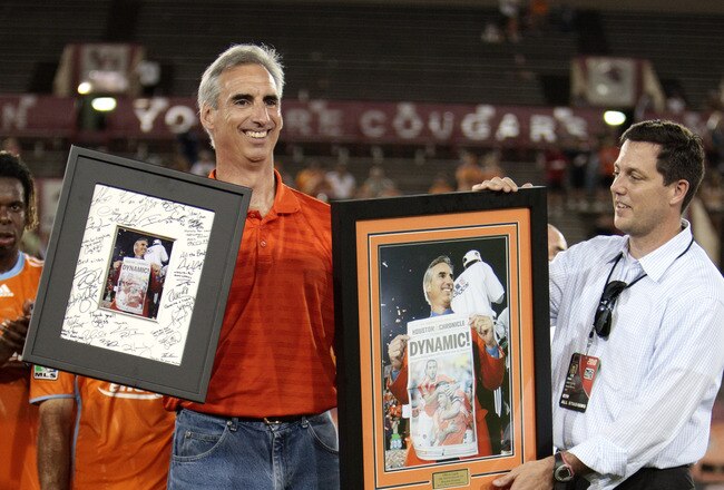 HOUSTON - JUNE 26:  Houston Dynamo President and General Manager Oliver Luck (L) receives some gifts from the Dynamo's Chris Canetti after the game at Robertson Stadium on June 26, 2010 in Houston, Texas. Luck is leaving the Dynamo to take the athletic directors position at West Virginia.  (Photo by Bob Levey/Getty Images)