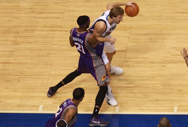 DALLAS, TX - JANUARY 04:  Dirk Nowitzki #41 of the Dallas Mavericks dribbles the ball against Hakim Warrick #21 of the Phoenix Suns at American Airlines Center on January 4, 2012 in Dallas, Texas.  Nowitzki was playing in his 1,000 career game.  NOTE TO USER: User expressly acknowledges and agrees that, by downloading and/or using this Photograph, user is consenting to the terms and conditions of the Getty Images License Agreement.  (Photo by Ronald Martinez/Getty Images)