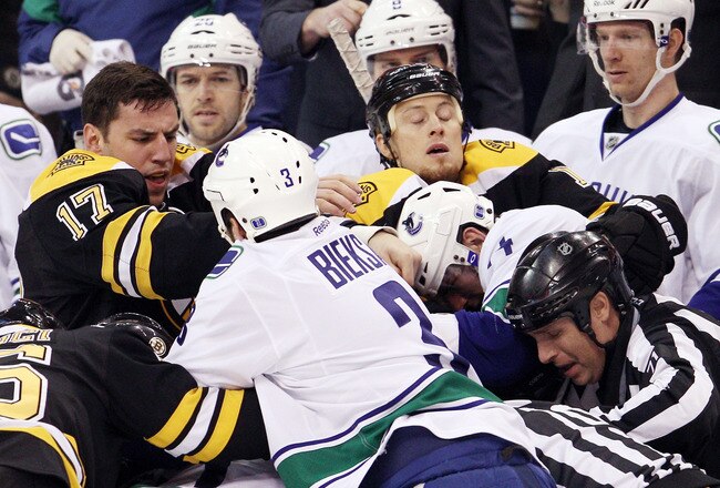 BOSTON, MA - JANUARY 07:  Milan Lucic #17 of the Boston Bruins fights with Kevin Bieksa #3 of the Vancouver Canucks in the first period on January 7, 2012 at TD Garden in Boston, Massachusetts.  (Photo by Elsa/Getty Images)