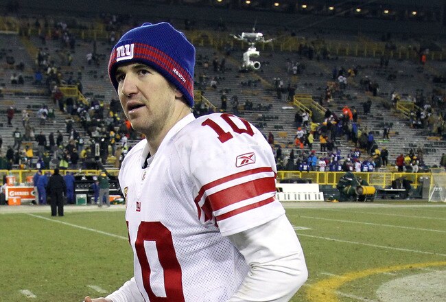 GREEN BAY, WI - JANUARY 15:   Eli Manning #10 of the New York Giants runs off the field against the Green Bay Packers during their NFC Divisional playoff game at Lambeau Field on January 15, 2012 in Green Bay, Wisconsin.  (Photo by Jonathan Daniel/Getty Images)