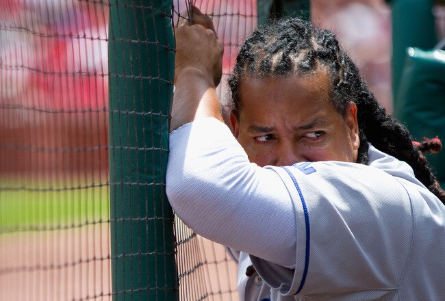 ST. LOUIS - JULY 18: Manny Ramirez #99 of the Los Angeles Dodgers looks on from the dugout against the St. Louis Cardinals at Busch Stadium on July 18, 2010 in St. Louis, Missouri.  The Cardinals beat the Dodgers 5-4.  (Photo by Dilip Vishwanat/Getty Images)